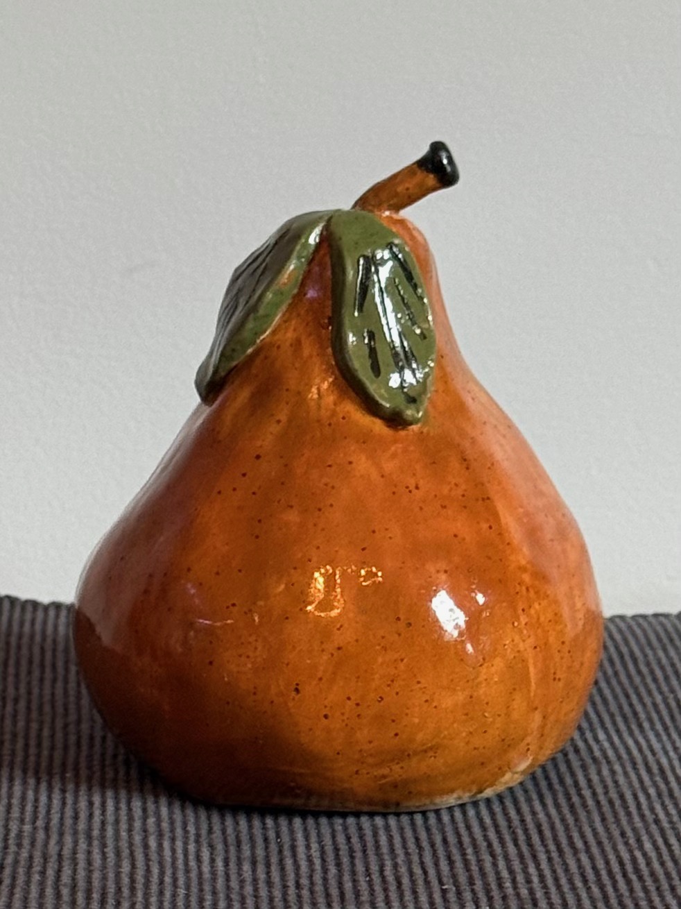 'Pear' - Realistic pear with leaves and stem.